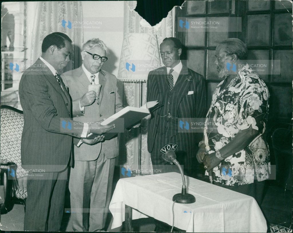President Mzee Jomo Kenyatta swears in Mr. Justice Chunnilal Bhagwandas Madan (second left)
