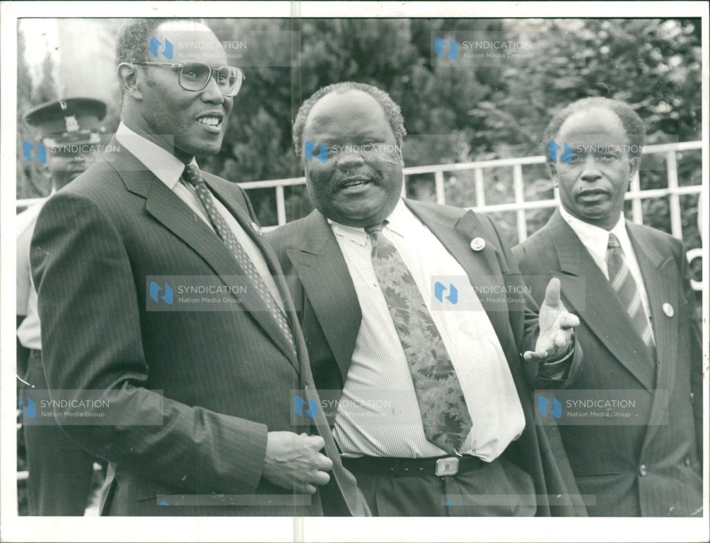 Vice President George Saitoti (left), chats with the Minister for Manpower Development and Employment, Mr. Oloo Aringo (center)