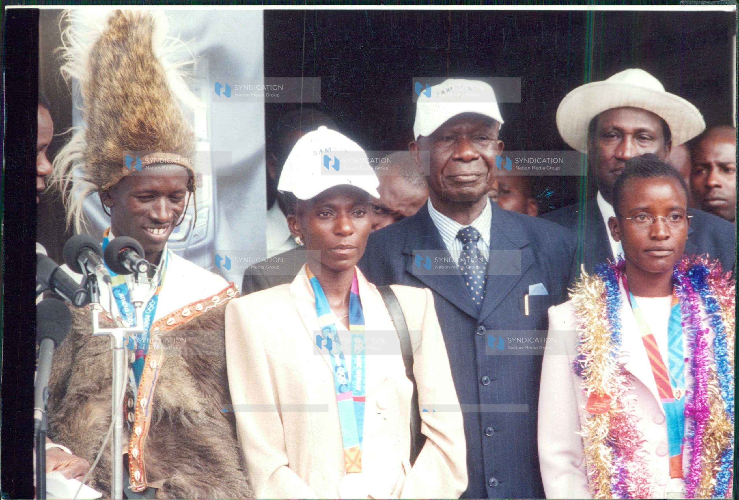 Vice-President Moody Awori with medalists Isabella Ochichi (right), Catherine Ndereba (second left) and Ezekiel Kemboi (left)