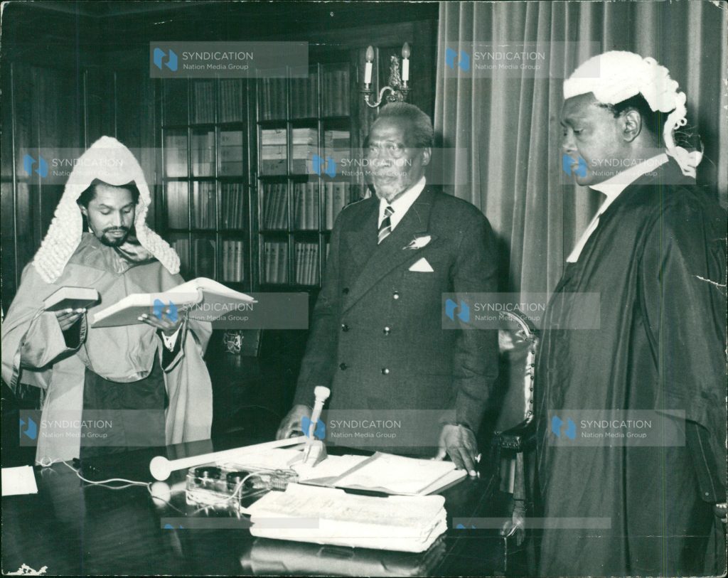 President Jomo Kenyatta (center) and Attorney-General Charles Mugane Njonjo (left). 