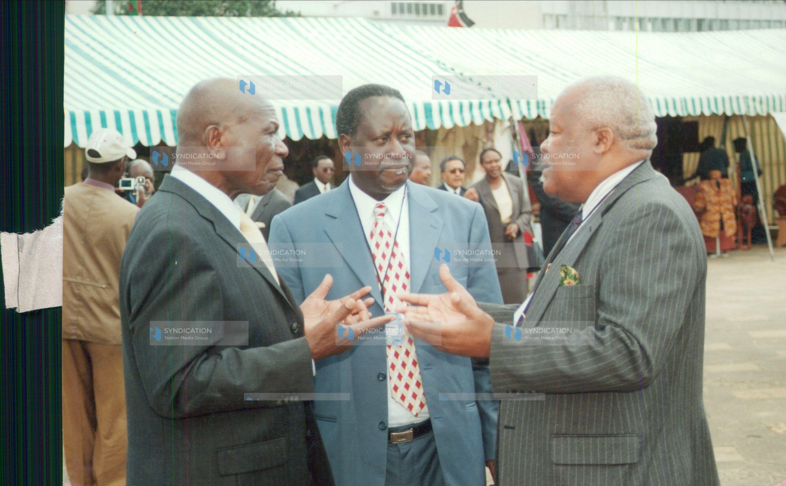 Vice-President Moody Awori (left) chats with Cabinet ministers Joseph Munyao (right) and Raila Odinga