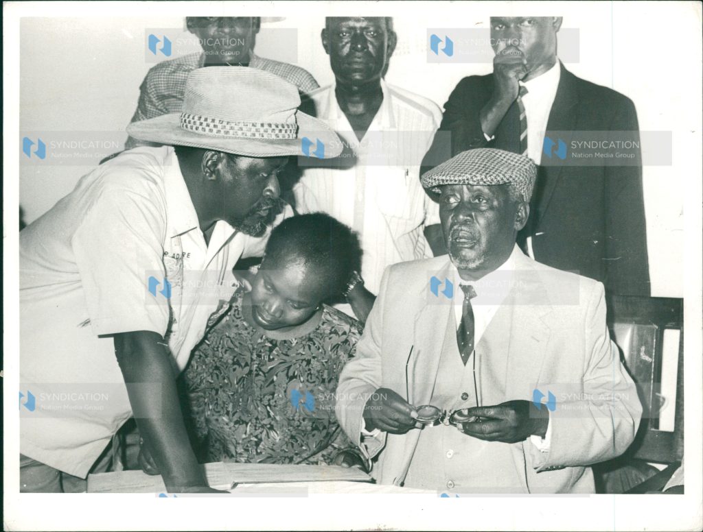 Lang'ata MP Raila Odinga (left), confers with his father, FORD-K chairman Jaramogi Oginga Odinga (right)