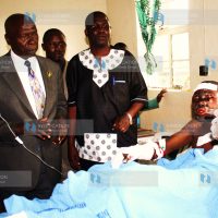 Former President Daniel Arap Moi consoles one of the Sachangwan fire victims