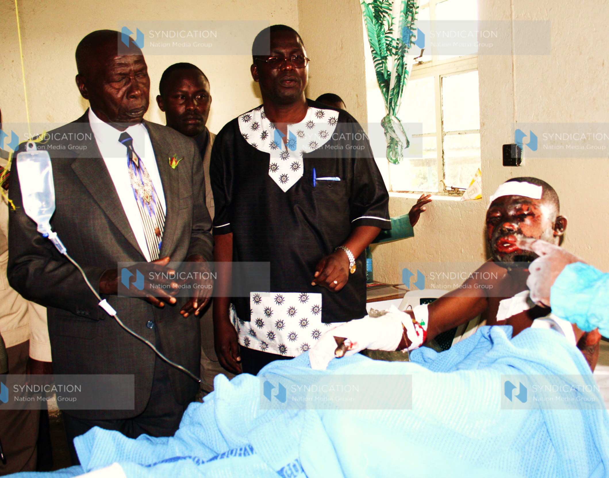 Former President Daniel Arap Moi consoles one of the Sachangwan fire victims