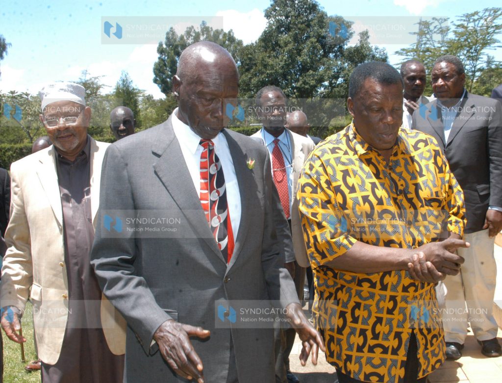Former President Daniel Arap Moi chats with former Presidential Service Unit staff Leonard Mambo Mbotela