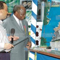 The chief executive officer of the TAL Group Twalib Hatayan shows President Mwai Kibaki the new proposed construction site
