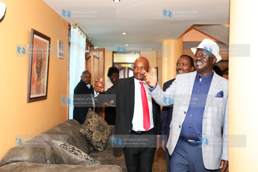 US-based law scholar Prof. Makau Mutua shows Opposition leader Raila Odinga and Wiper leader Kalonzo Musyoka one of the portraits