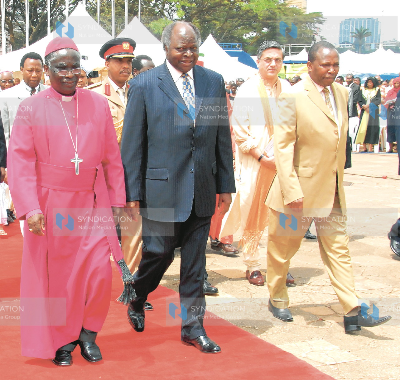 President Mwai Kibaki is escorted by Bishop Benjamin Ndzimbi and Minister Maina Kamanda