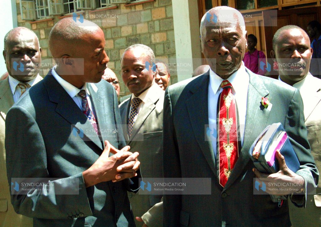 Former President Daniel Arap Moi listens to Rev. Justus Mutuku