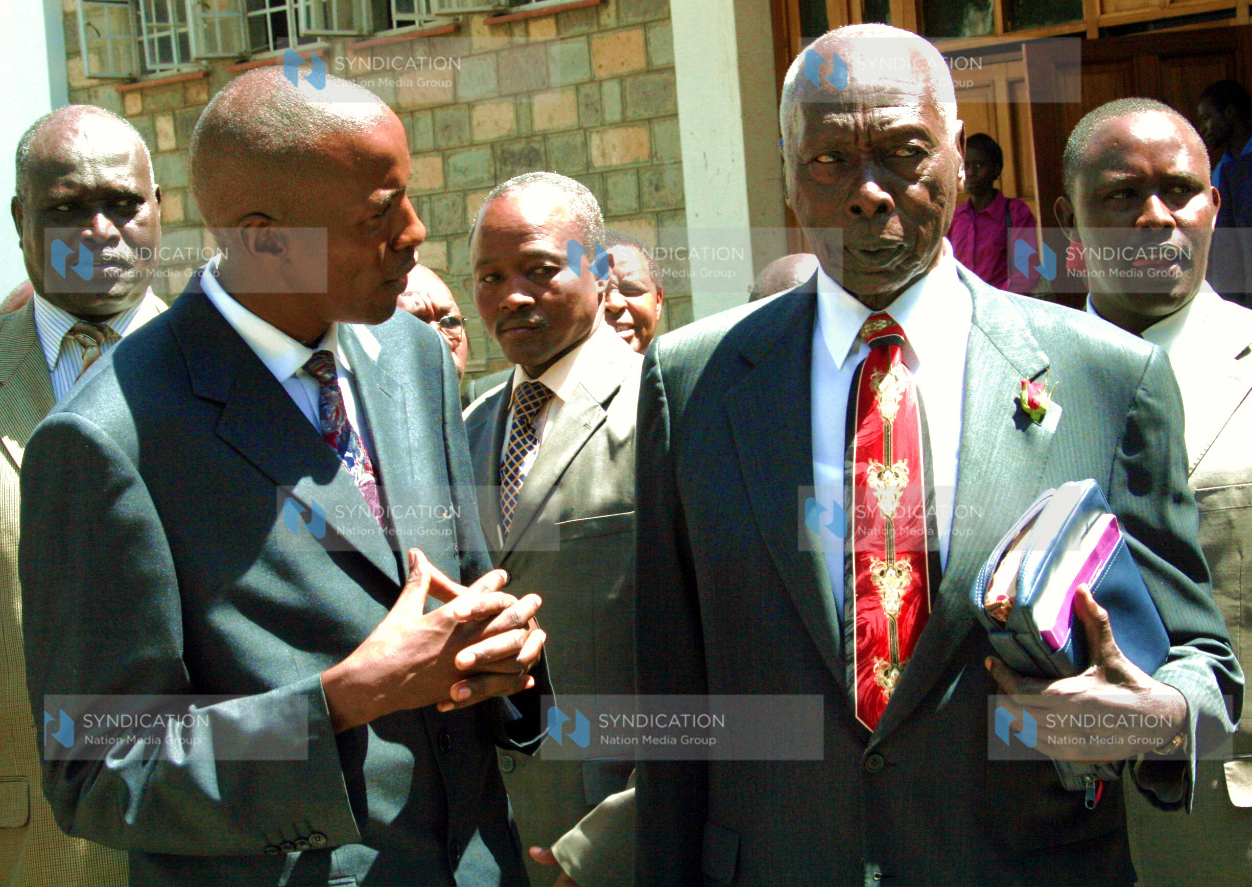 Former President Daniel Arap Moi listens to Rev. Justus Mutuku