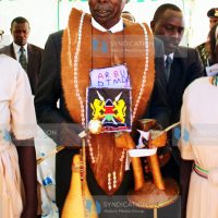 Former President Daniel Arap Moi carries gifts presented to him by Kereger Women Group