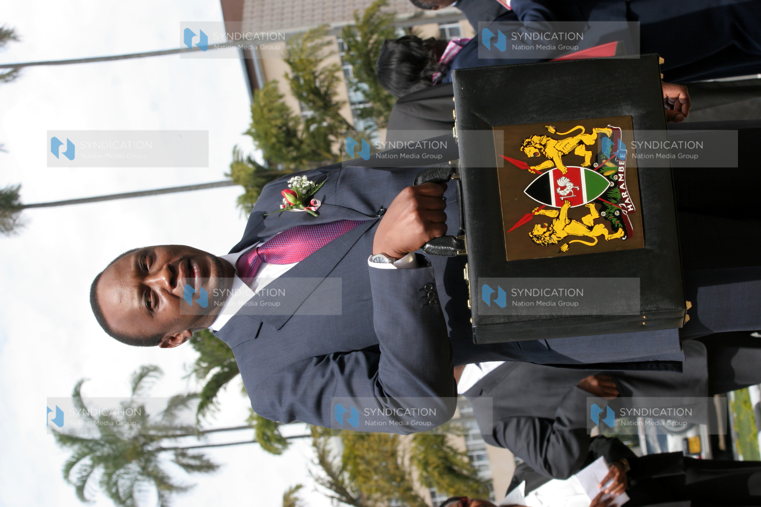 Finance Minister Uhuru Kenyatta arrives with his briefcase for this year’s presentation of the budget