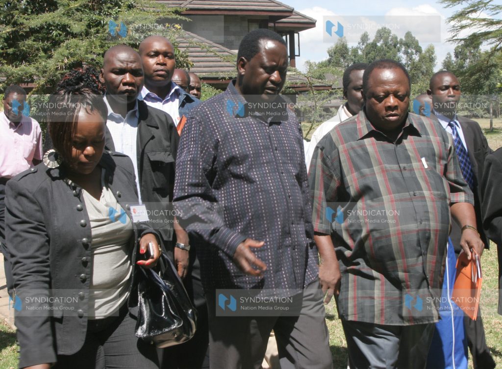 Prime Minister Raila Odinga with Ramadhan Kajembe and Millie Odhiambo