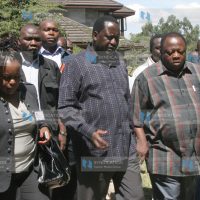 Prime Minister Raila Odinga with Ramadhan Kajembe and Millie Odhiambo