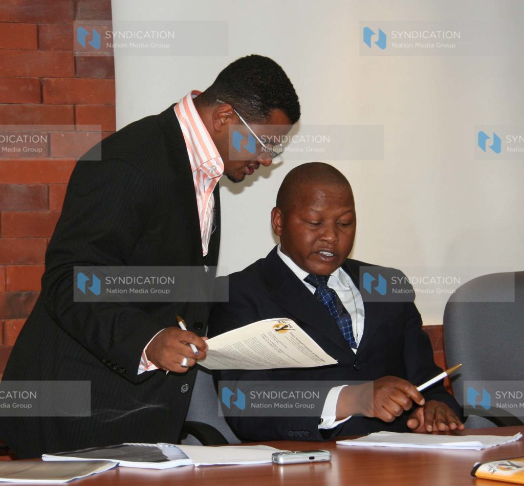 KNCHR Commissioner Mr. Hassan Omar Hassan chats with Senior Human Rights Officer Mr. Kamanda Mucheke