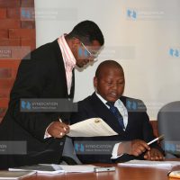 KNCHR Commissioner Mr. Hassan Omar Hassan chats with Senior Human Rights Officer Mr. Kamanda Mucheke