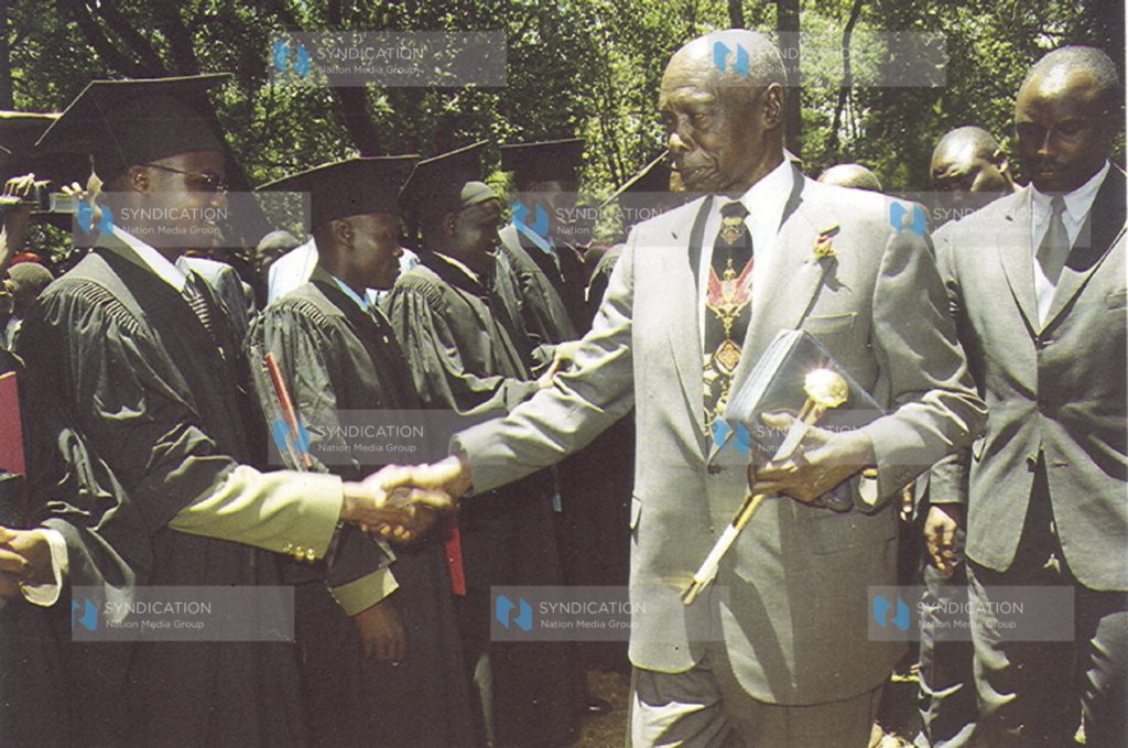 Former President Daniel Arap Moi congratulates one of the Graduands