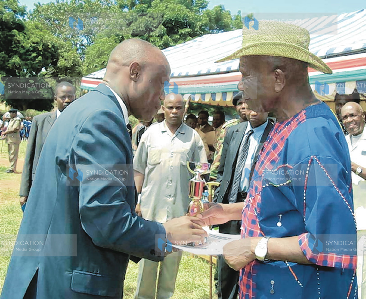 Vice President Moody Awori presents trophy to the Principal of Sigalame Secondary School Mr. Paul Muhula