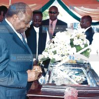 President Mwai Kibaki views the body of the late Ramogi Achieng Oneko