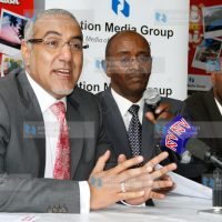 Tourism minister Najib Balala flanked with Uchumi managing director Jonathan Ciano and NMG general manager marketing Dr Githai Githinji