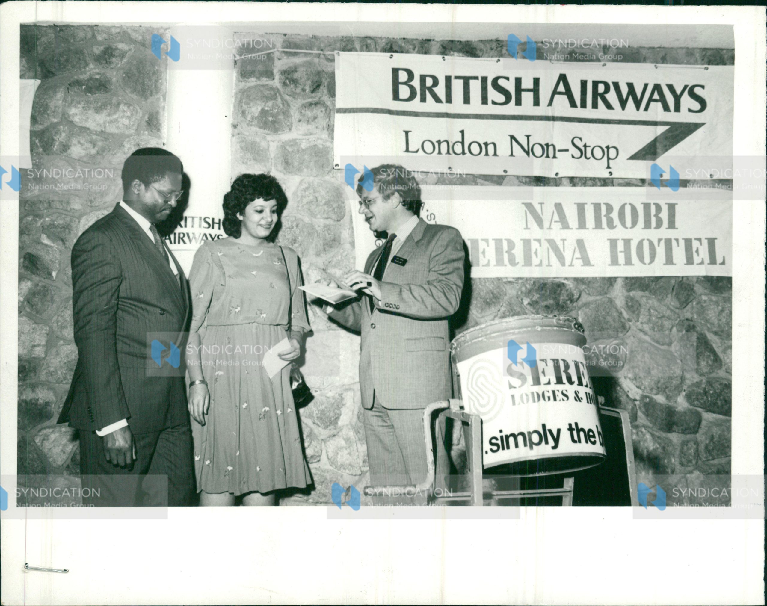 Munira Pirbahai, a secretary with E A Packaging Industries receives a return air ticket to London from Mrs. Chris Cross, British Airways’ manager for Kenya Mr. John Macharia, the airline’s sales manager