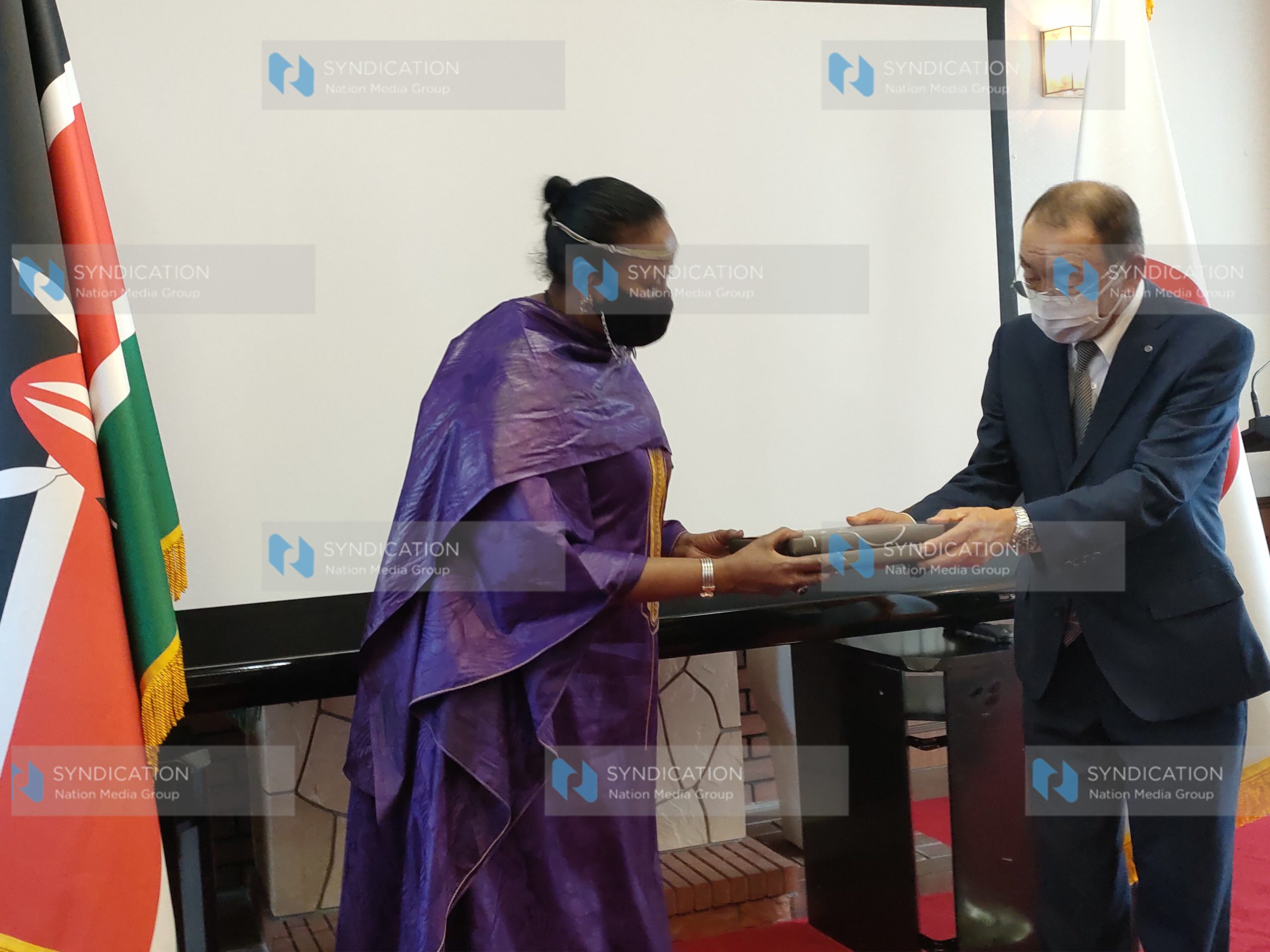 Sports Cabinet Secretary Amina Mohamed receives a gift from Yasuto Motomura, the chairman of the Kurume Chamber of Commerce and Industry