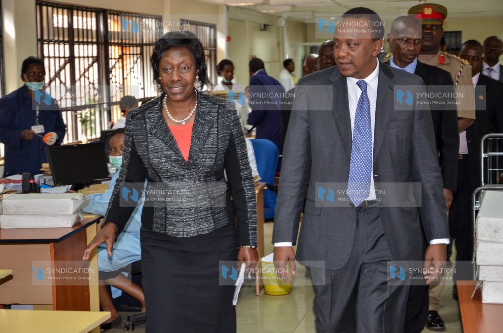 President Uhuru Kenyatta is conducted on a tour of the Lands Registry Department by Lands Cabinet Secretary Ms. Charity Ngilu