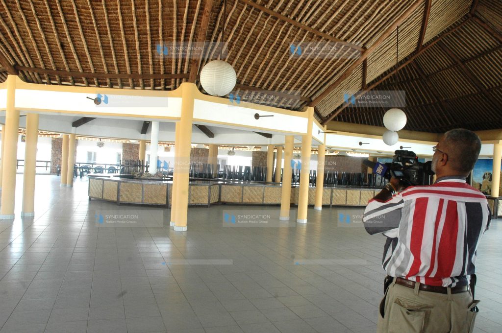 A cameraman at the main restaurant of the Coral-Palm Beach Hotel