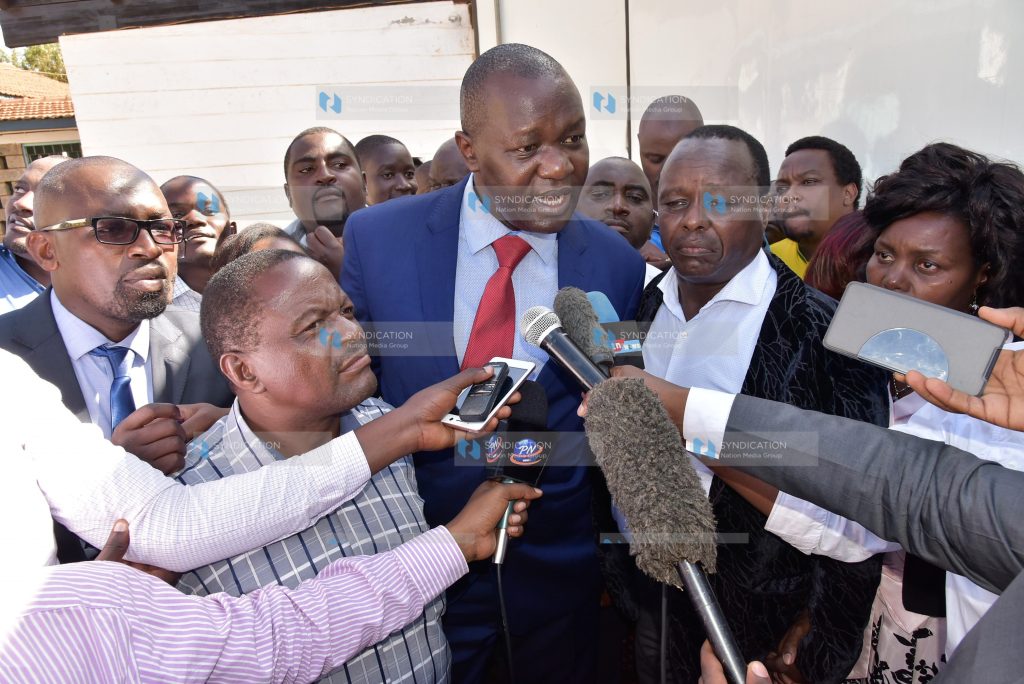 Lawyer Tom Ojienda (in red tie) addresses the press after his client