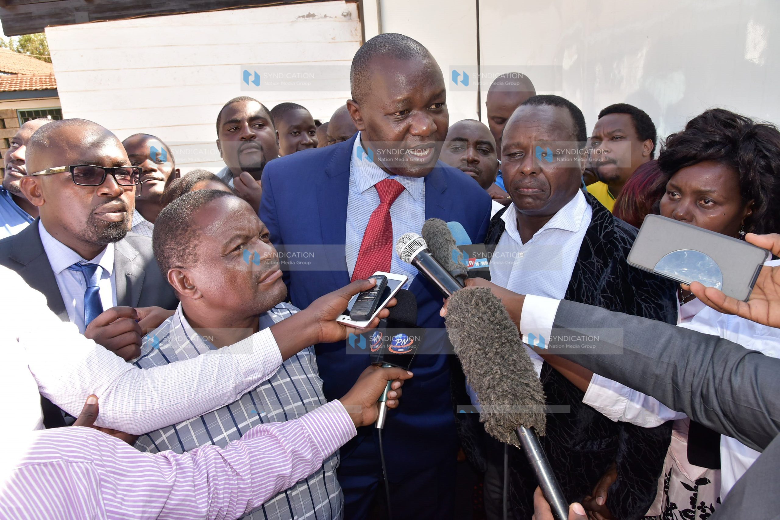 Lawyer Tom Ojienda (in red tie) addresses the press after his client