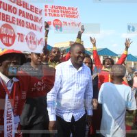 Kigumo MP Jamleck Kamau, is ushered to a podium during a political rally by leaders from Mt Kenya region