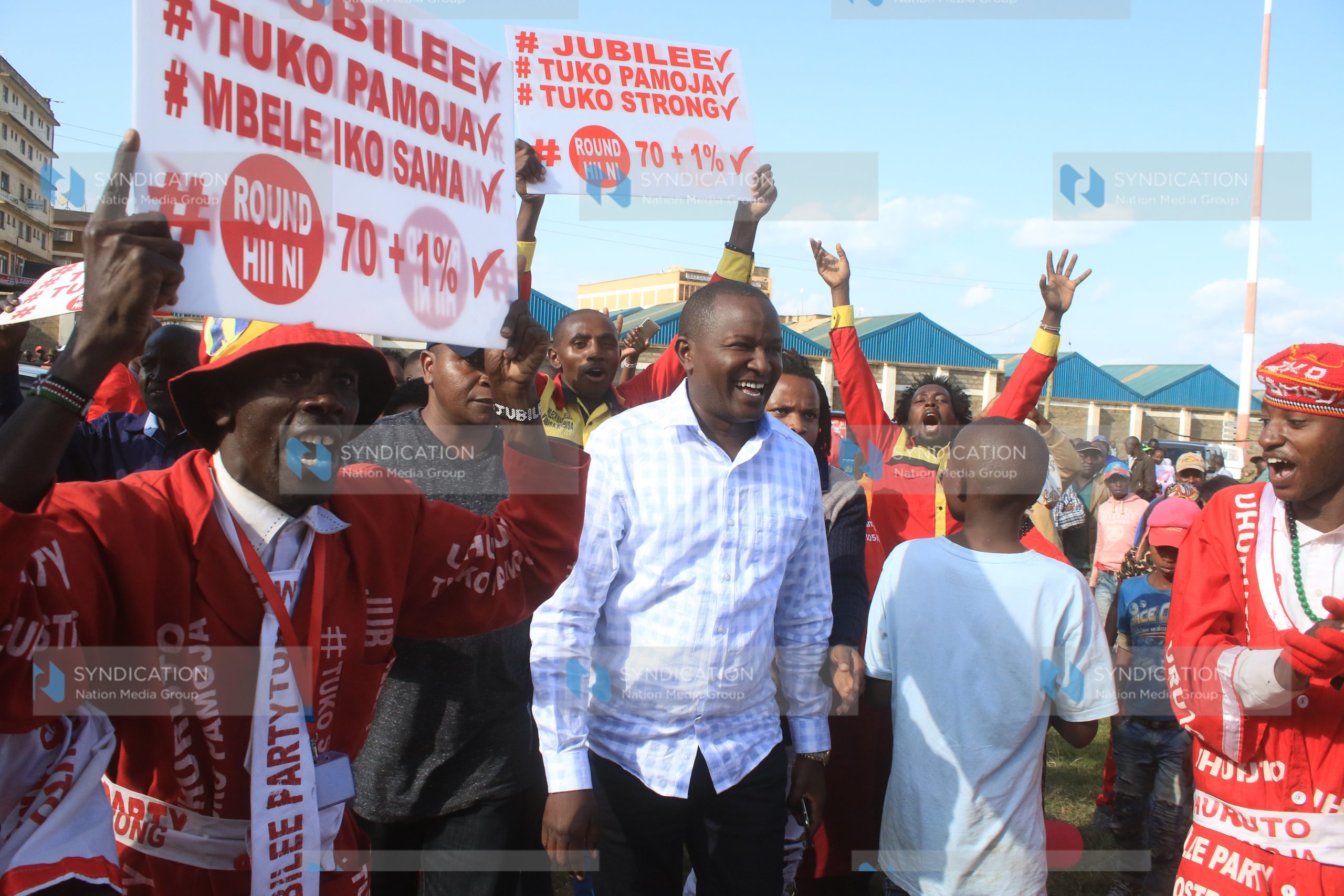 Kigumo MP Jamleck Kamau, is ushered to a podium during a political rally by leaders from Mt Kenya region