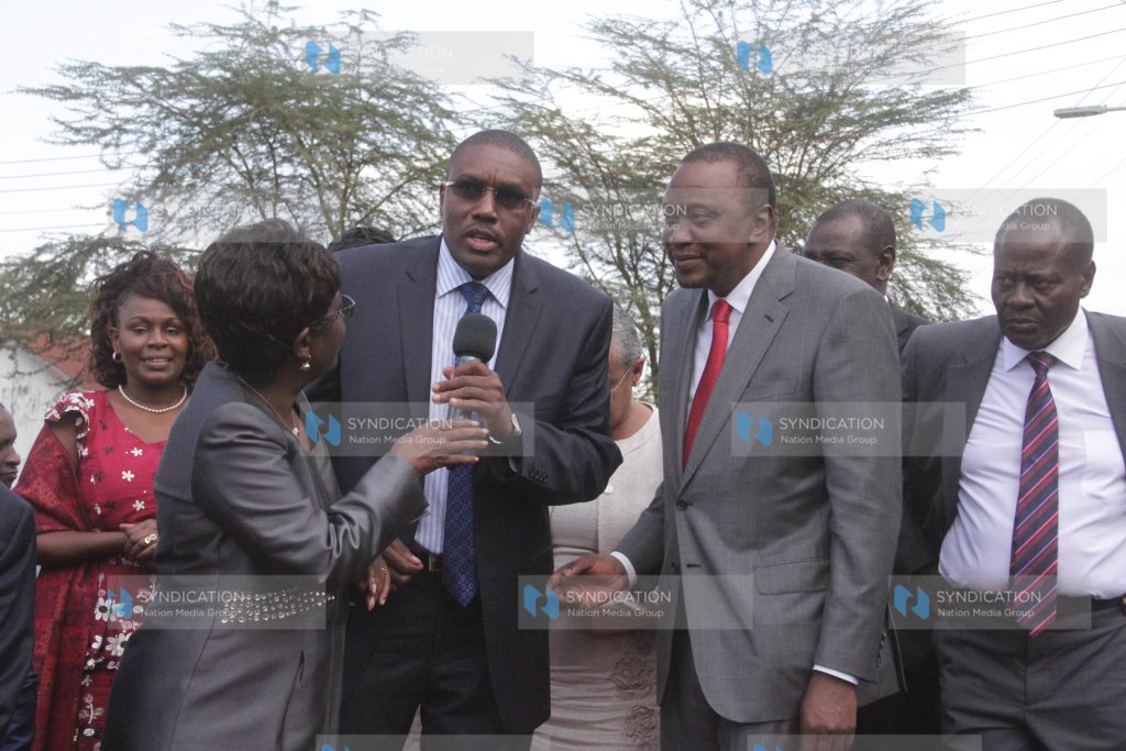 President Uhuru Kenyatta listens as Mukurweini MP Kabando wa Kabando