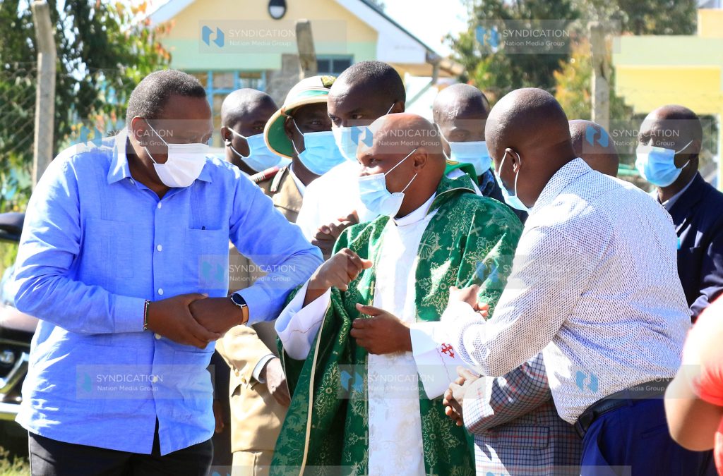 President Uhuru Kenyatta is welcomed by Fr Samuel Njigwa on arrival at Chaka Catholic church in Nyeri County