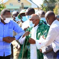 President Uhuru Kenyatta is welcomed by Fr Samuel Njigwa on arrival at Chaka Catholic church in Nyeri County