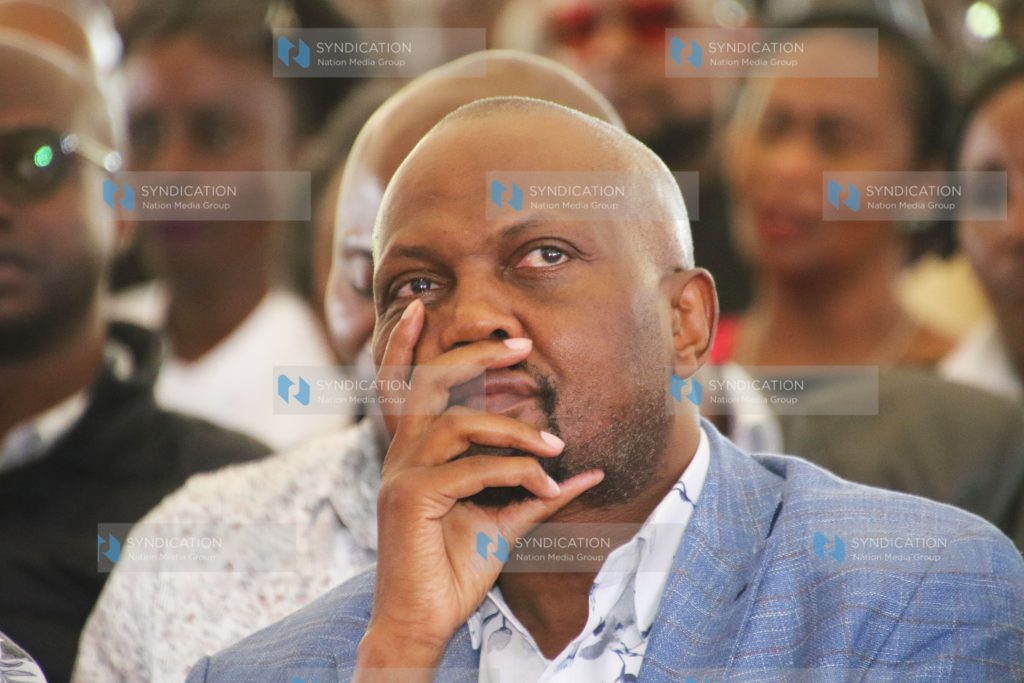 Moses Kuria follows proceedings during the burial ceremony