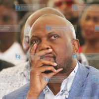 Moses Kuria follows proceedings during the burial ceremony
