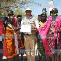 Najib Balala hands over the certificate of the best tourism village