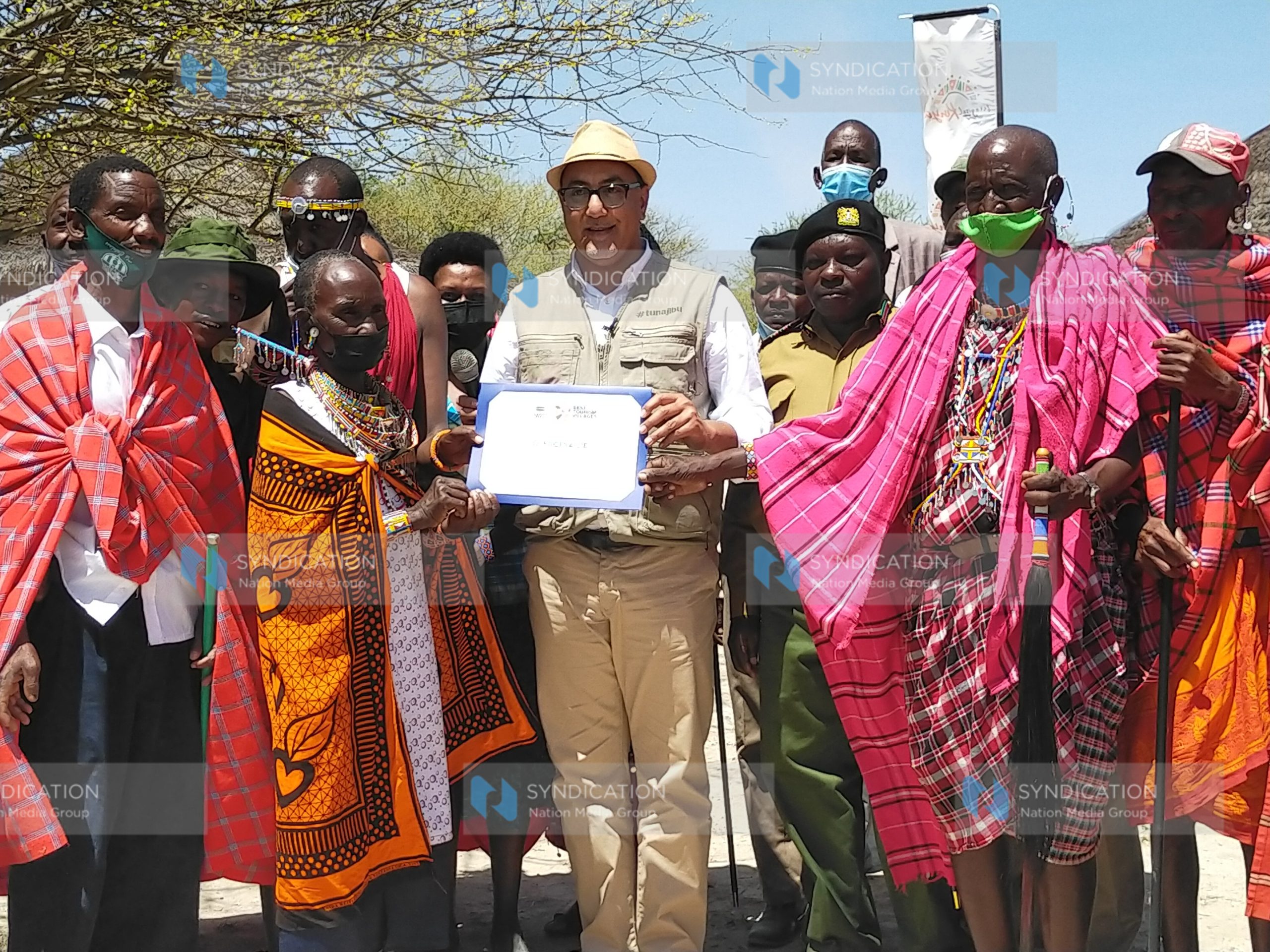 Najib Balala hands over the certificate of the best tourism village