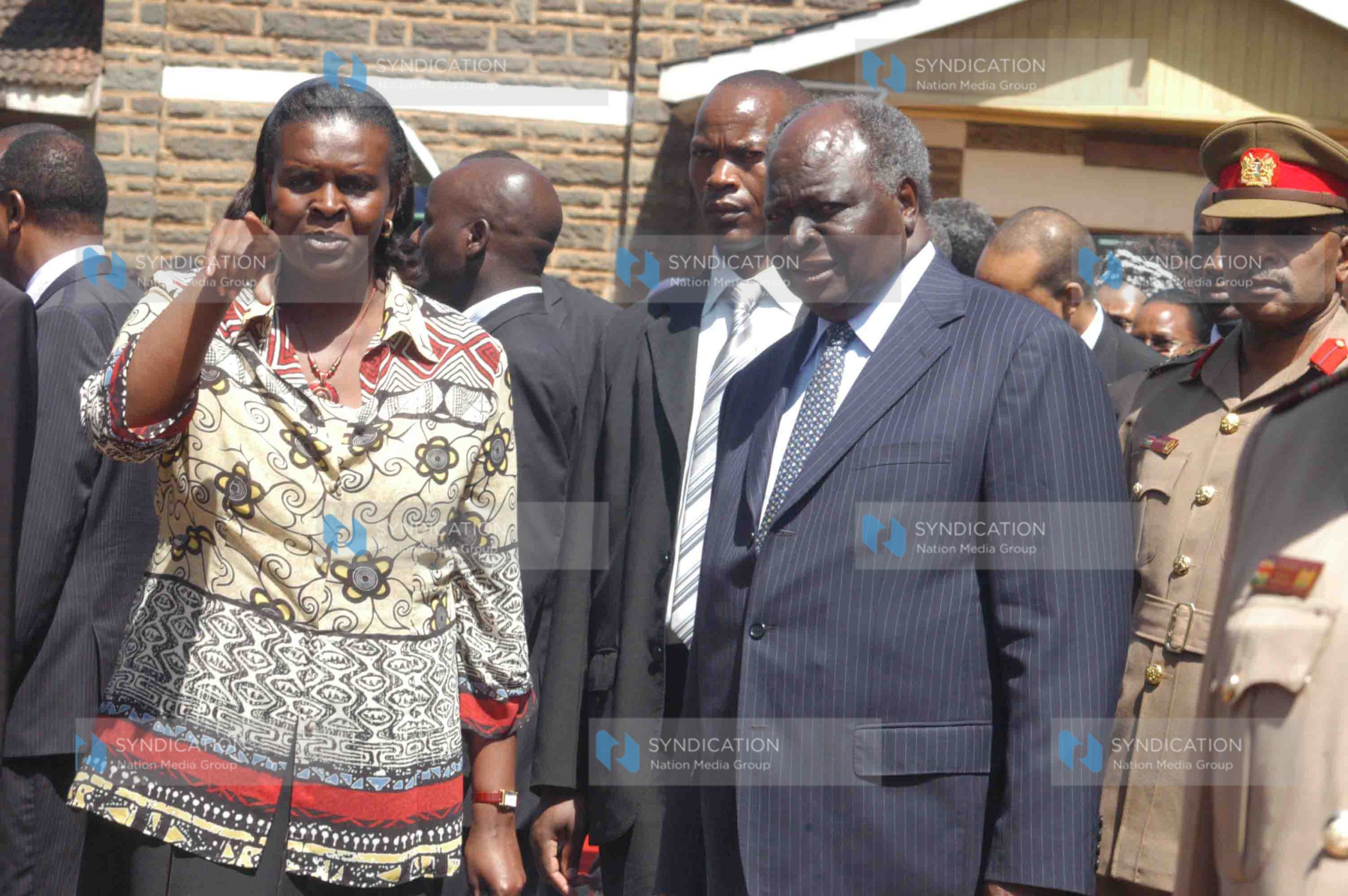 President Mwai Kibaki discusses something with his daughter Judy