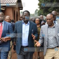 Former Prime Minister Raila Odinga interacts with Professor Karanja Njoroge (right)