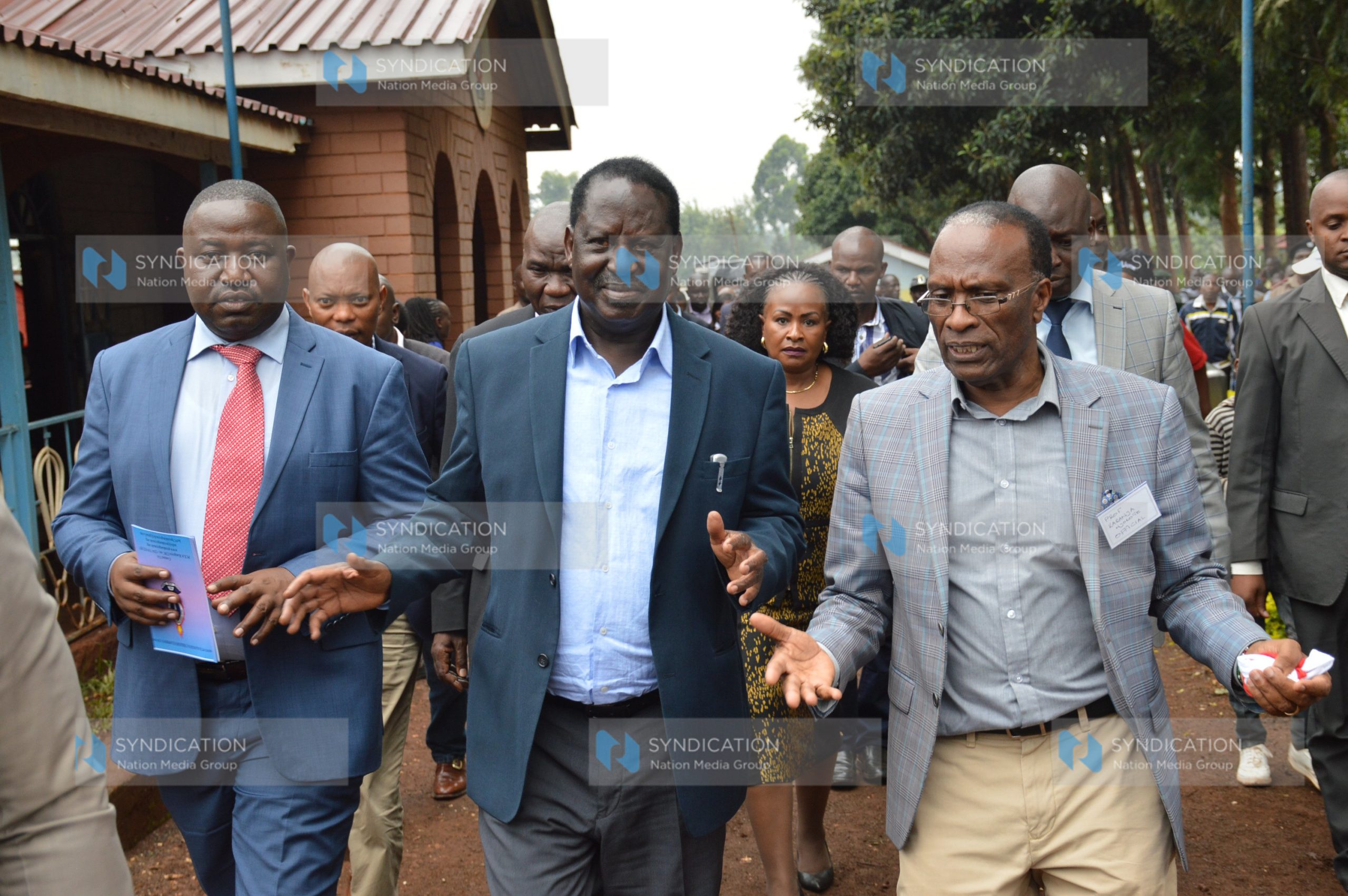 Former Prime Minister Raila Odinga interacts with Professor Karanja Njoroge (right)