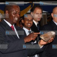 Amos Kimunya Minister for Trade looks at a shoe on display at the Turkey Trade Fair