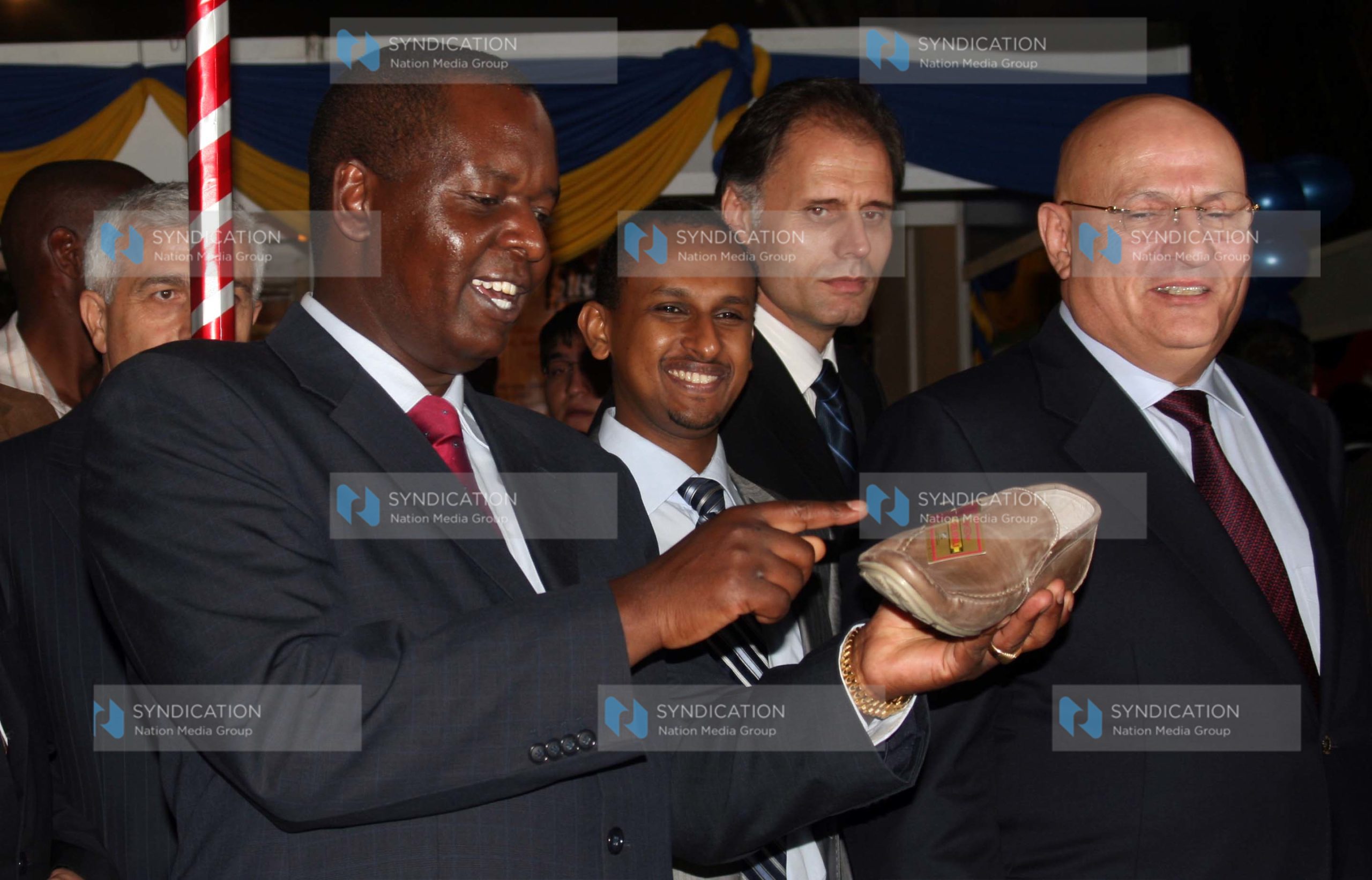 Amos Kimunya Minister for Trade looks at a shoe on display at the Turkey Trade Fair