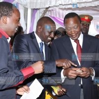 President Uhuru Kenyatta and Deputy President William Ruto are shown a shoe-making product