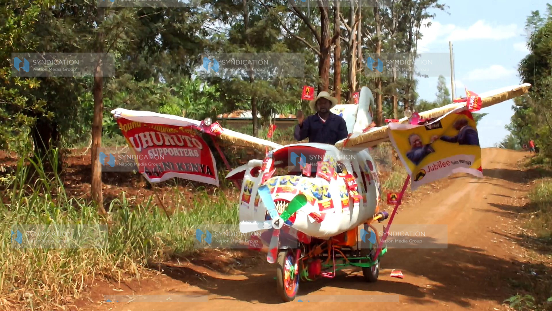 Cyrus Njiru rides a contraption that looks like an airplane