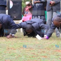 Pastors kneel during a prayer meeting for peace at Gichira Stadium