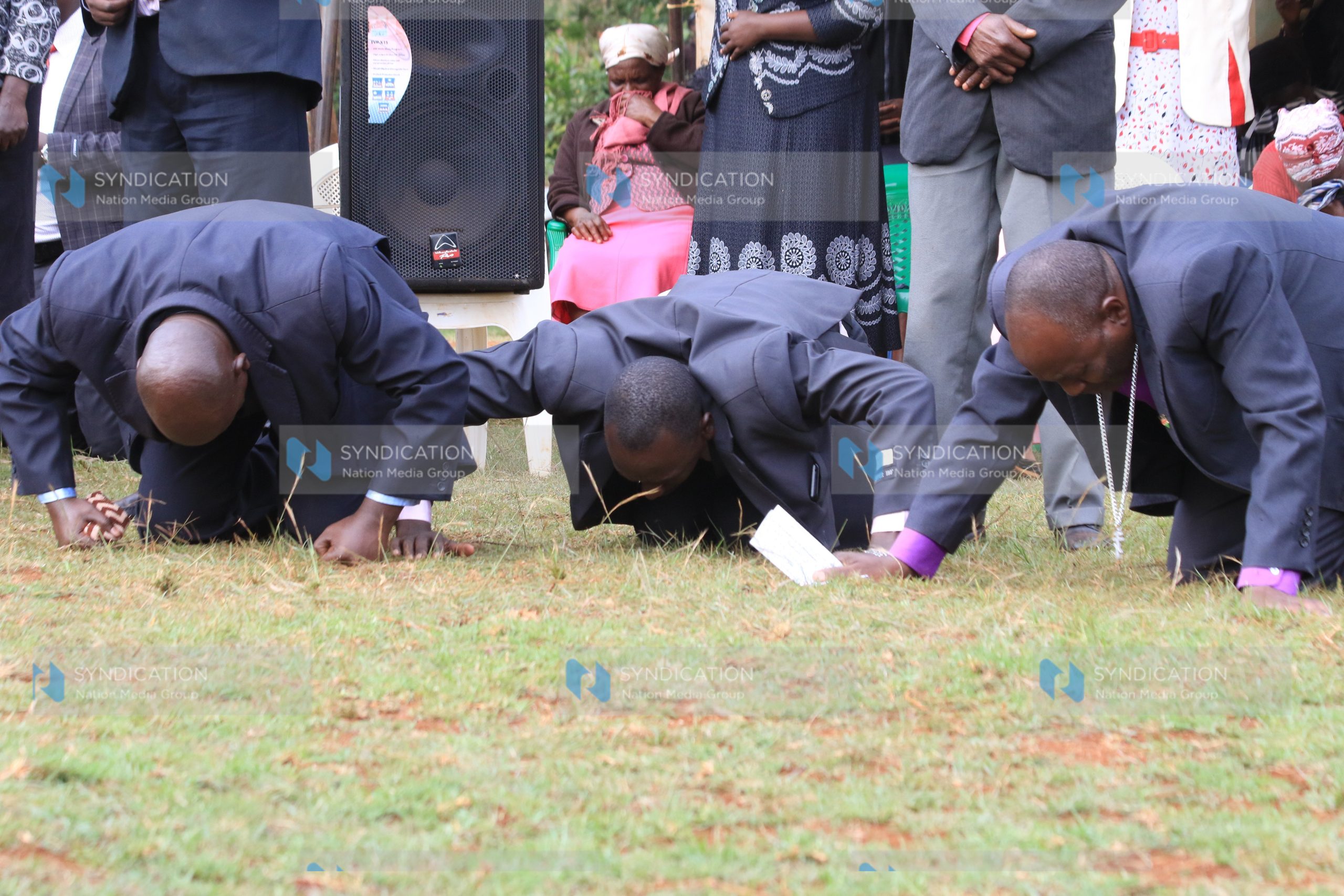 Pastors kneel during a prayer meeting for peace at Gichira Stadium