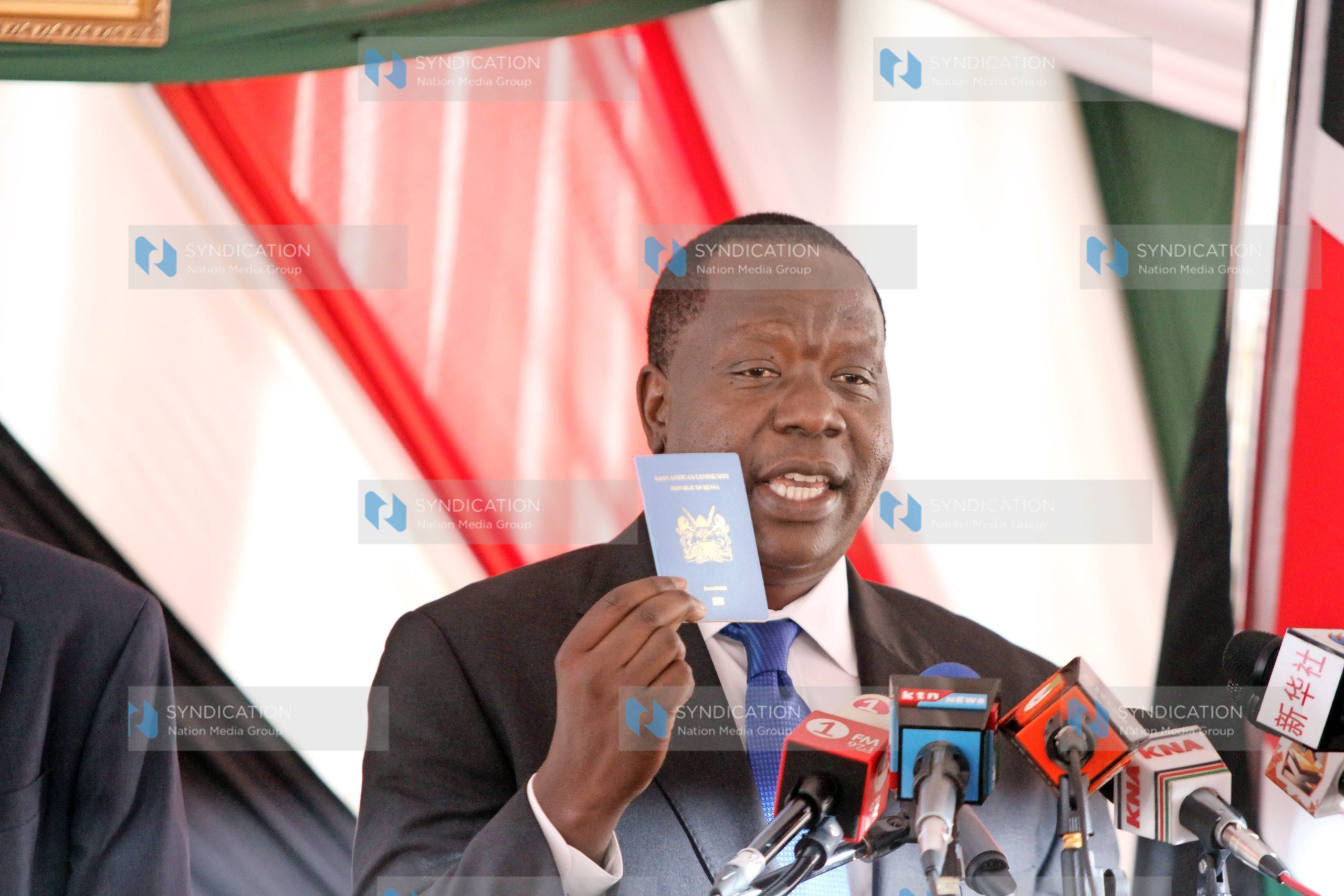 Fred Matiang’i displays the new e-passport launched at the Nairobi immigration offices