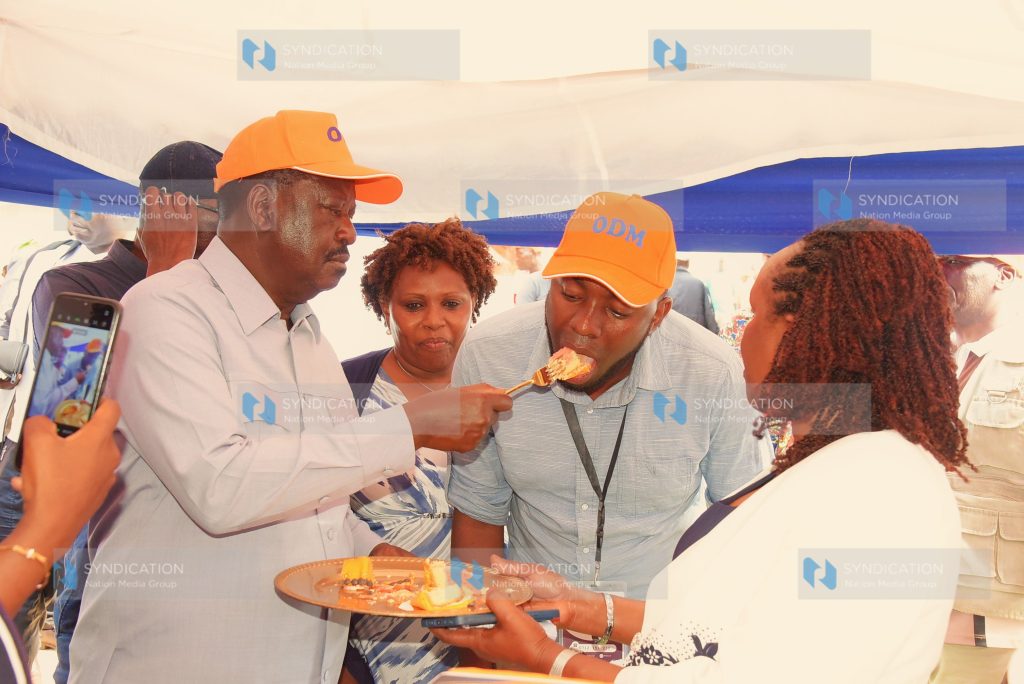 Azimio leader Raila Odinga feeds a guest cake